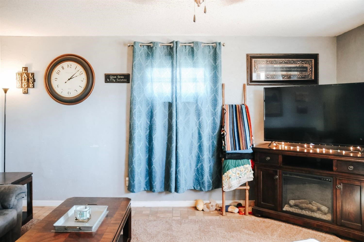 309 Ranch Street Ropesville, TX 79358 - Photo 5 of 26 a living room with furniture a flat screen tv and a fireplace