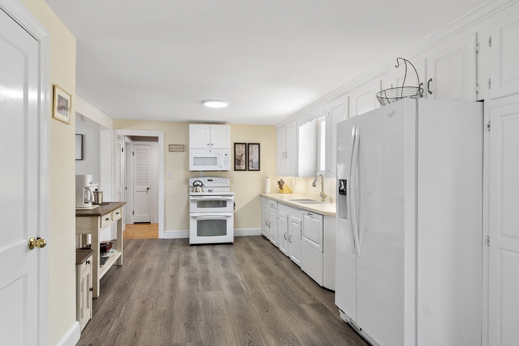 18 Rainbow Circle Peabody, MA 01960 - Photo 13 of 39 a kitchen with stainless steel appliances a refrigerator and a stove top oven