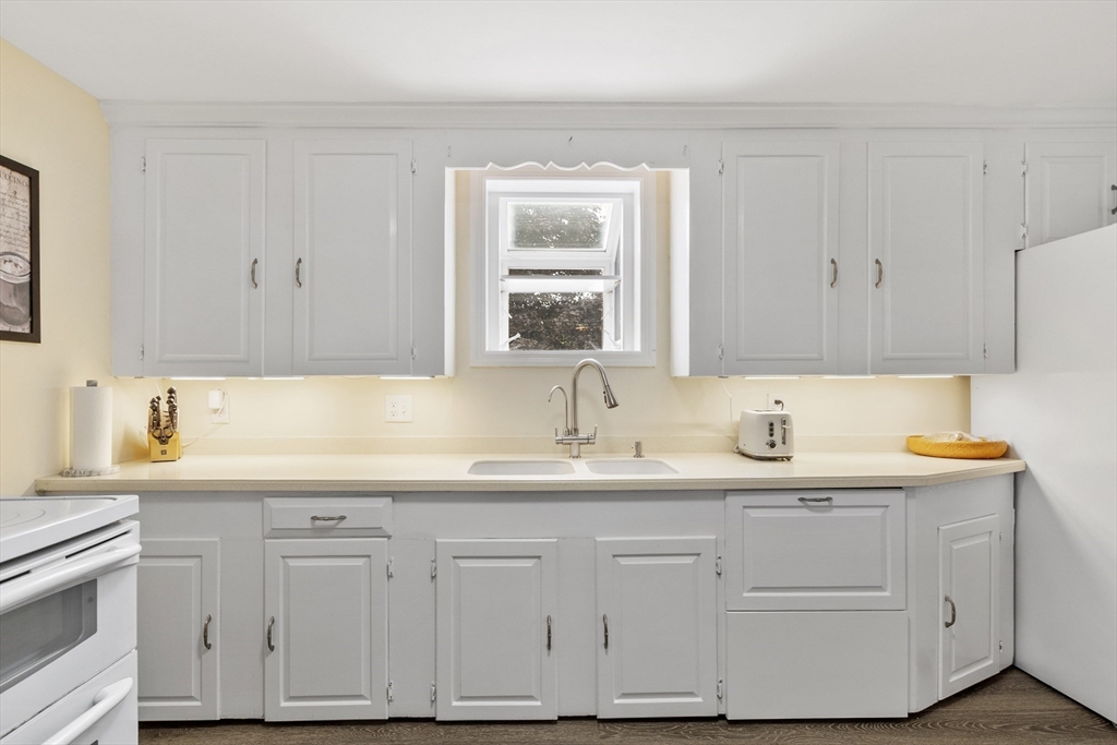 18 Rainbow Circle Peabody, MA 01960 - Photo 14 of 39 a kitchen with white cabinets and sink