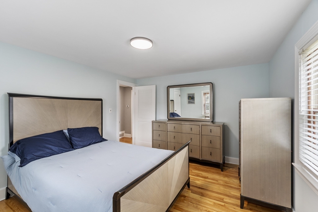 18 Rainbow Circle Peabody, MA 01960 - Photo 18 of 39 a bedroom with a bed and wooden floor
