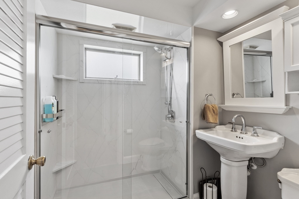 18 Rainbow Circle Peabody, MA 01960 - Photo 20 of 39 a bathroom with a sink a mirror and a shower