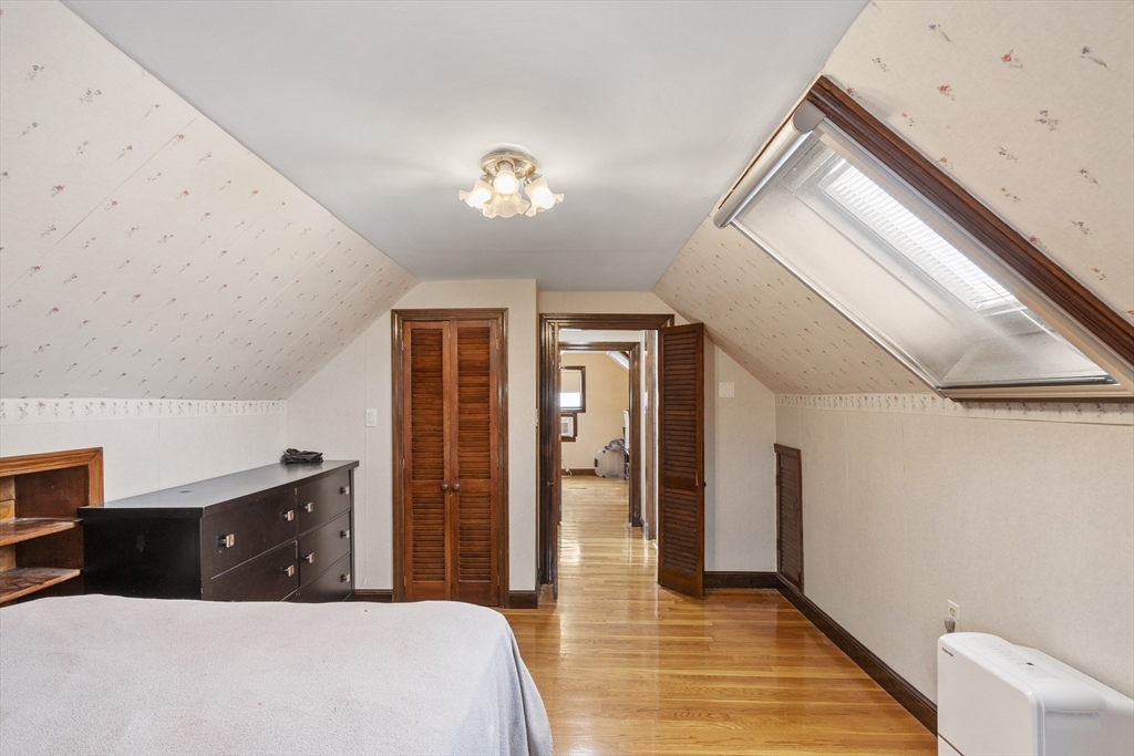 18 Rainbow Circle Peabody, MA 01960 - Photo 22 of 39 a bedroom with a bed and a chandelier
