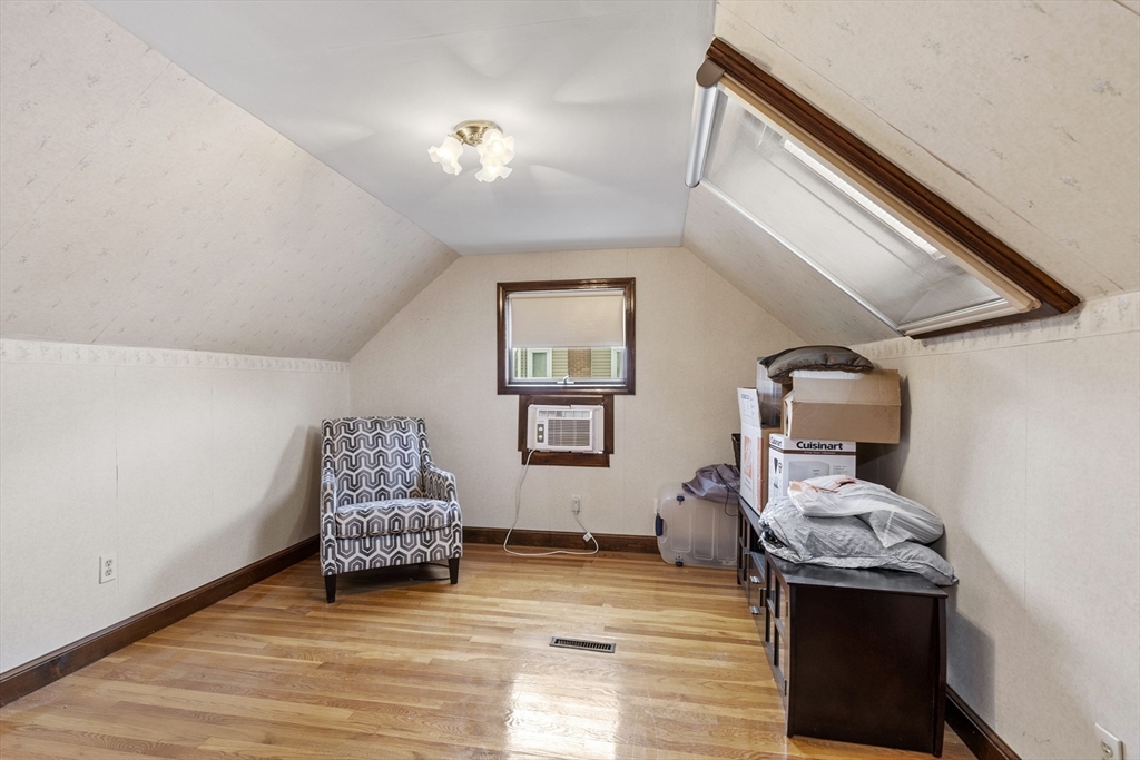 18 Rainbow Circle Peabody, MA 01960 - Photo 24 of 39 a bedroom with a bed and wooden floor