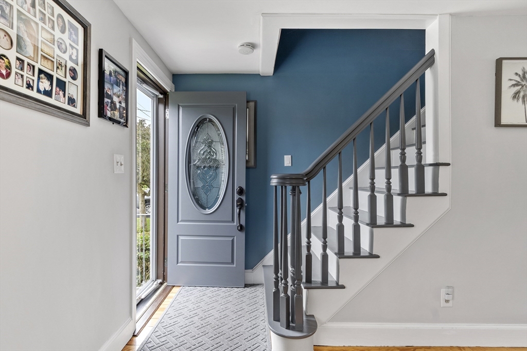 18 Rainbow Circle Peabody, MA 01960 - Photo 3 of 39 a view of staircase with lots of frames on wall and a large window