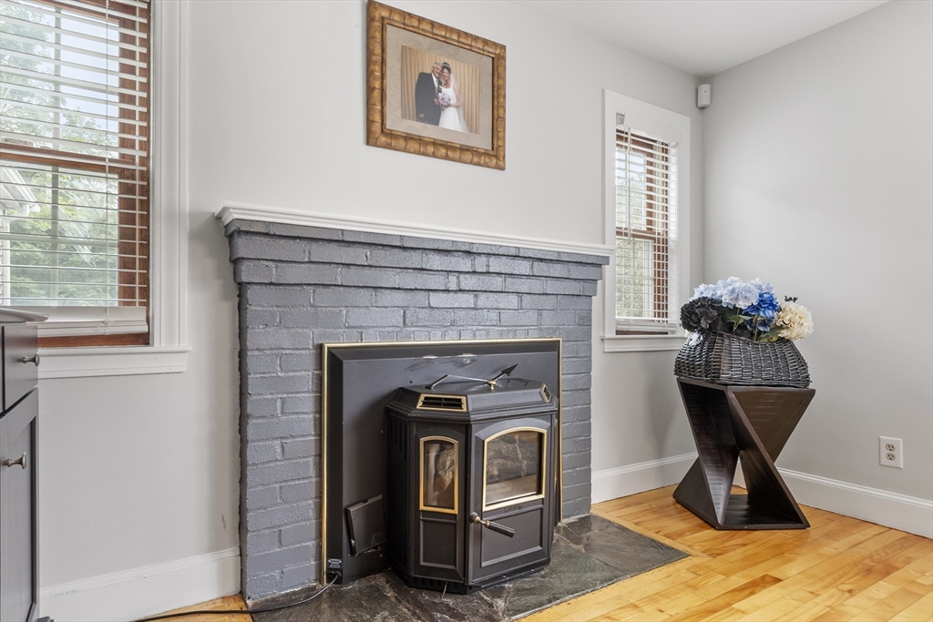 18 Rainbow Circle Peabody, MA 01960 - Photo 6 of 39 a living room with a fireplace and a table