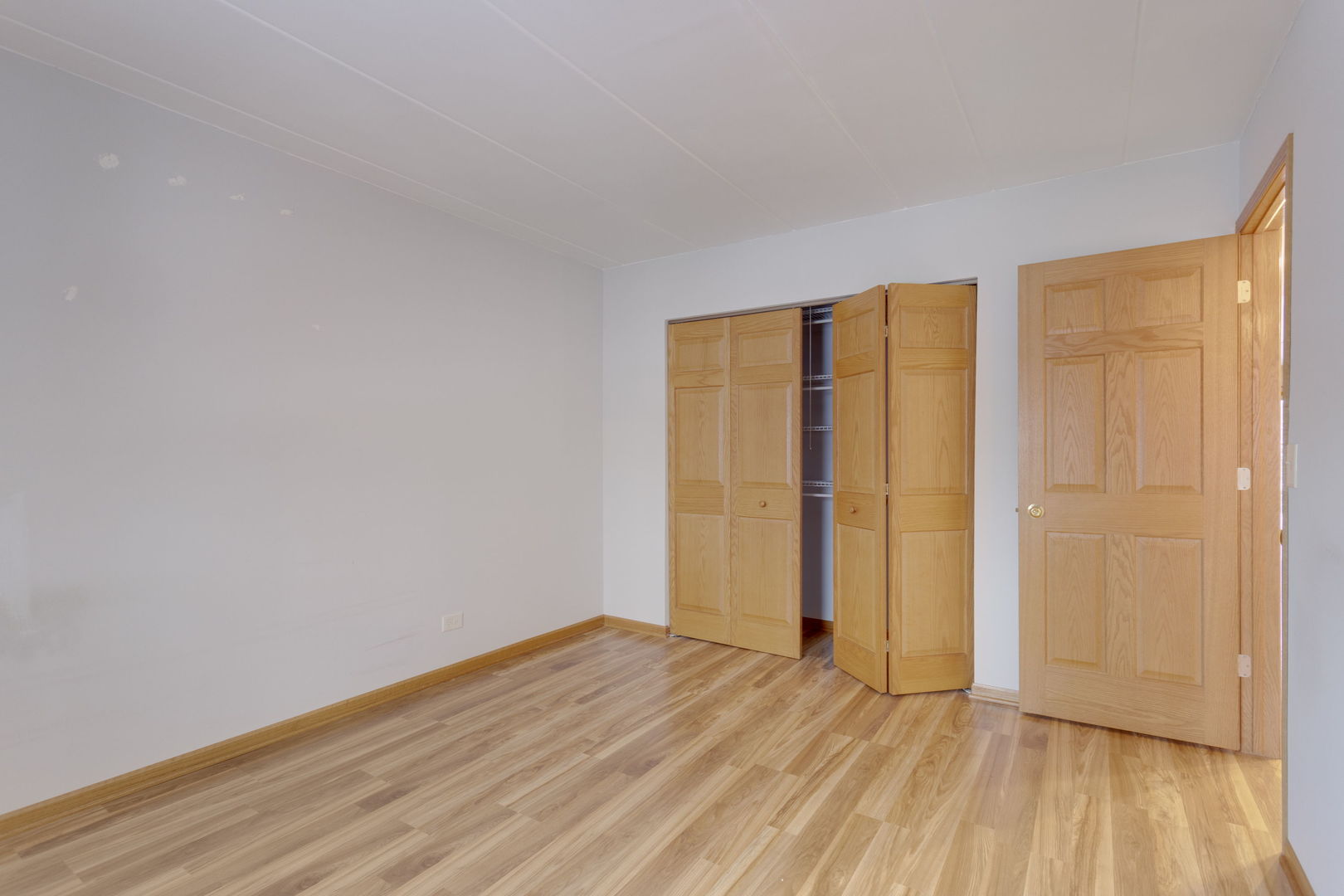 2505 Spring Street, Unit 3304 Woodridge, IL 60517 - Photo 11 of 17 a view of an empty room with wooden floor and a window