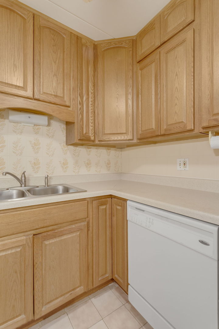 2505 Spring Street, Unit 3304 Woodridge, IL 60517 - Photo 13 of 17 a kitchen with granite countertop white cabinets and stainless steel appliances