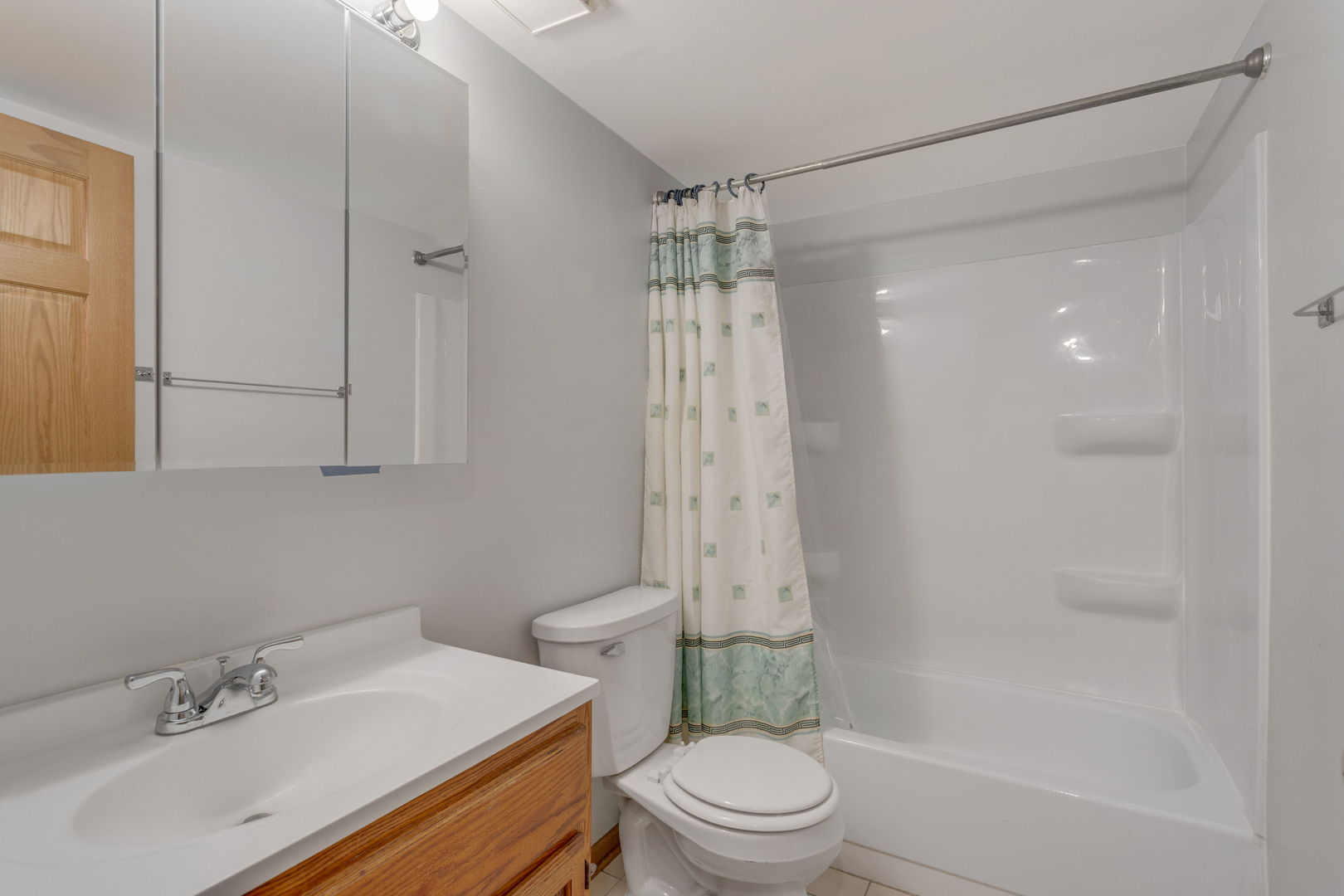 2505 Spring Street, Unit 3304 Woodridge, IL 60517 - Photo 6 of 17 a bathroom with a sink a toilet and shower