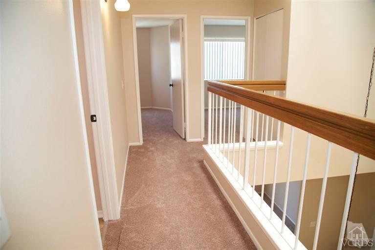 1736 Sinaloa Road, Unit 323 Simi Valley, CA 93065 - Photo 14 of 24 a view of a hallway with wooden floor and staircase
