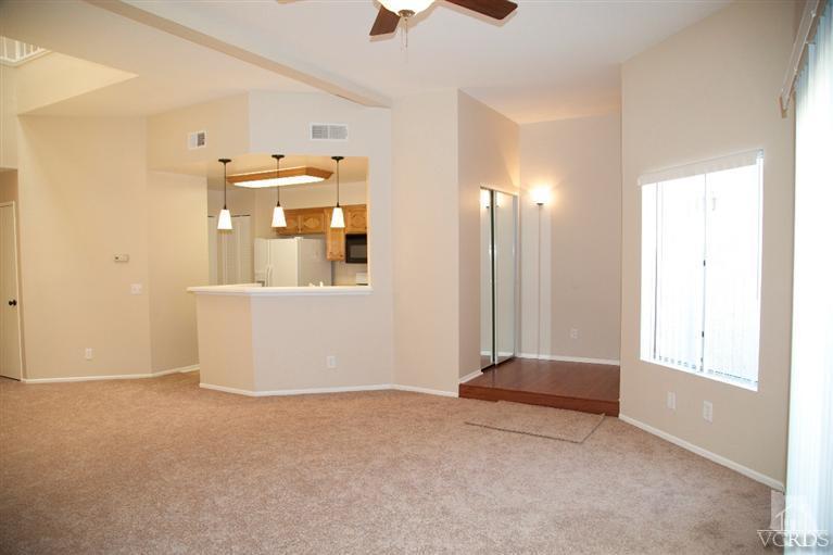 1736 Sinaloa Road, Unit 323 Simi Valley, CA 93065 - Photo 3 of 24 an empty room with chandelier fan and windows