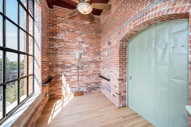 a view of a balcony with wooden floor and iron stairs