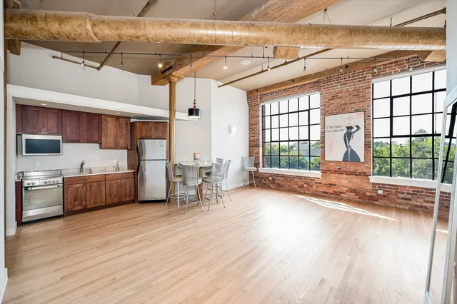 a view of a room with wooden floor and furniture