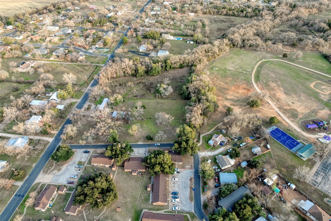 Lot 4 East Alamo Street Elgin, TX 78621 - Photo 11 of 14 an aerial view of a house with a yard and lake view