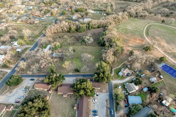 an aerial view of a house with a yard and lake view