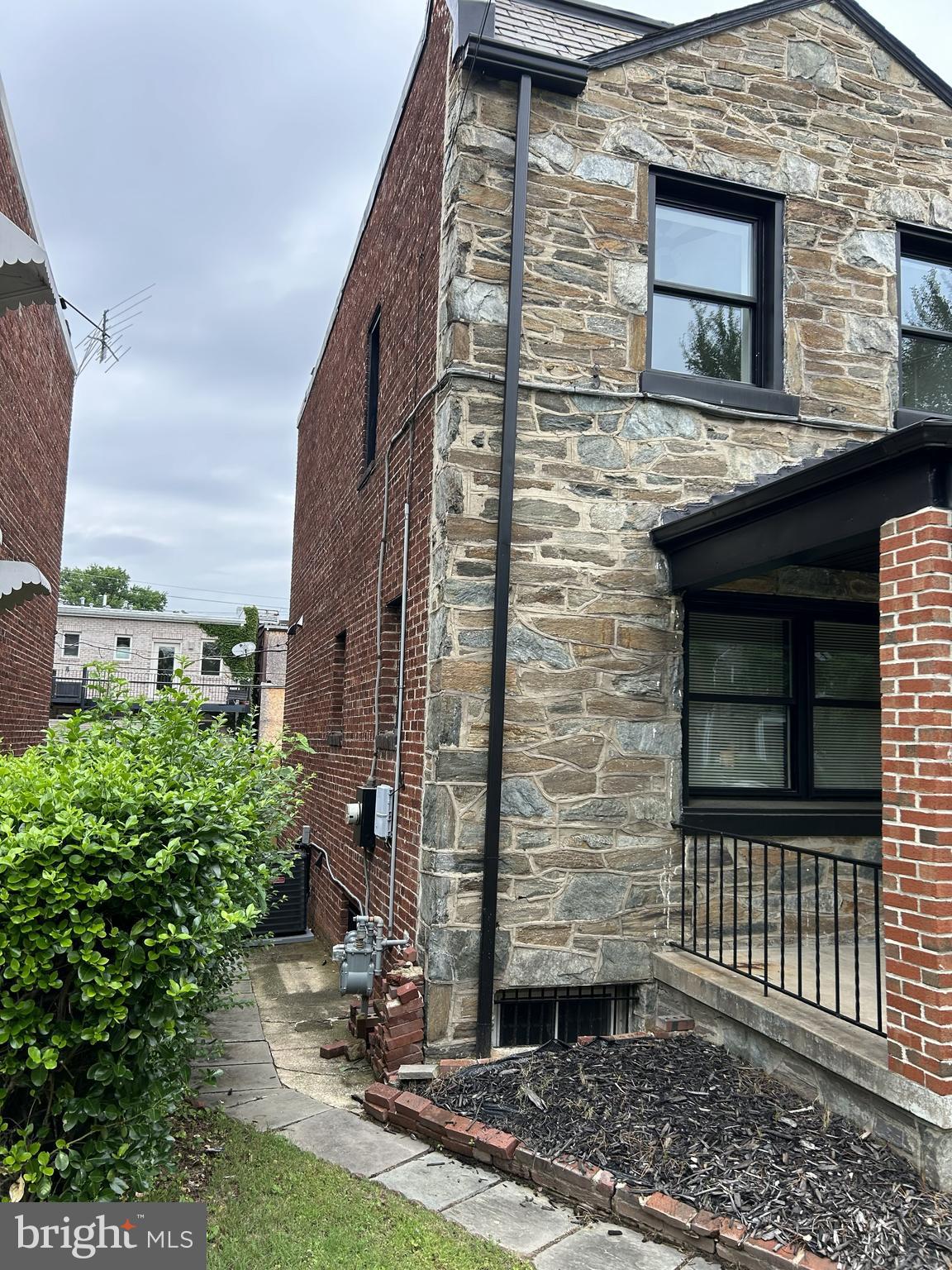 928 Perry Place Northeast Washington, DC 20017 - Photo 2 of 16 a front view of a house with a yard