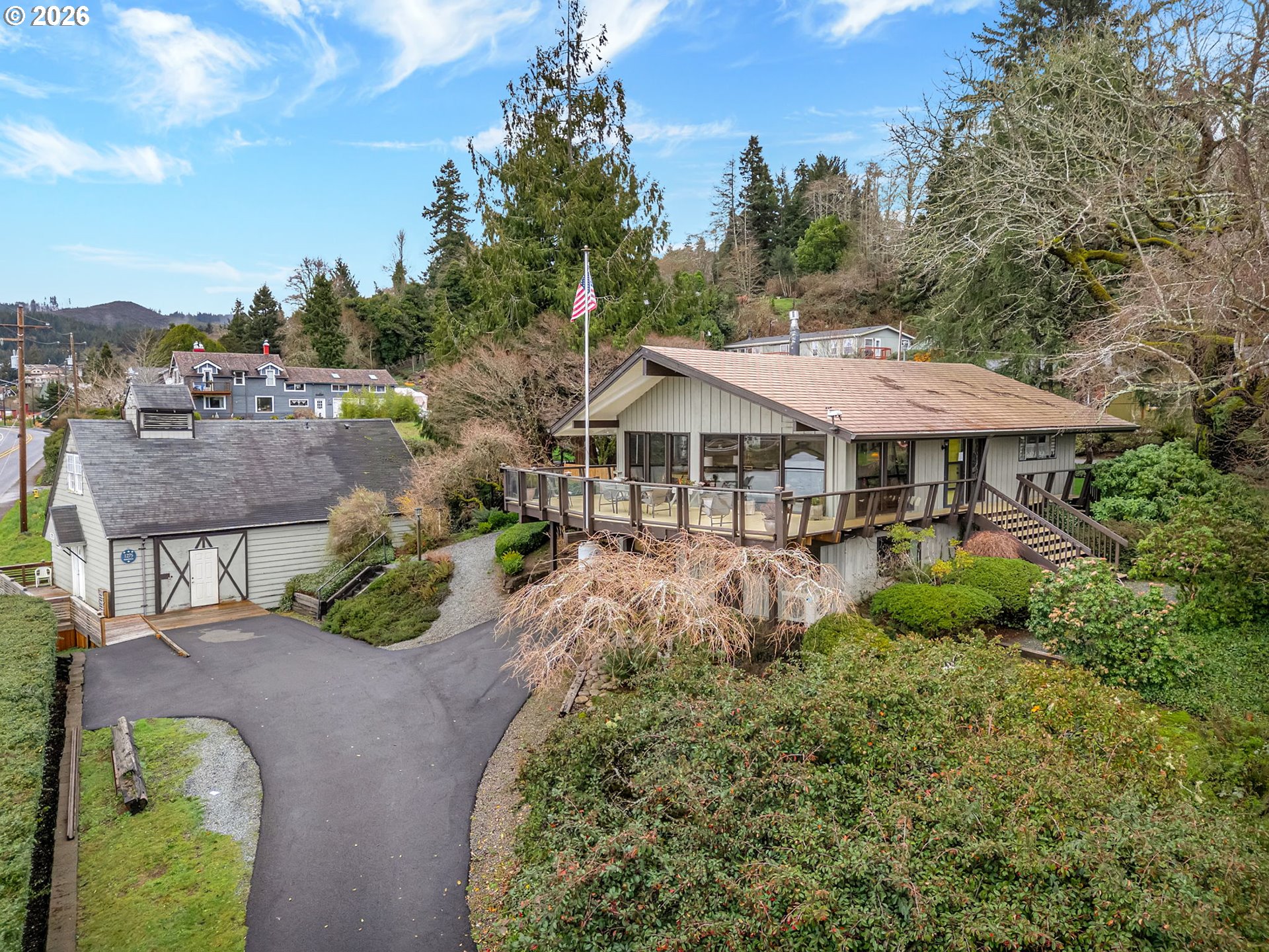 61 Gamble Street Wheeler, OR 97147 - Photo 1 of 45 a view of a patio with table and chairs under an umbrella