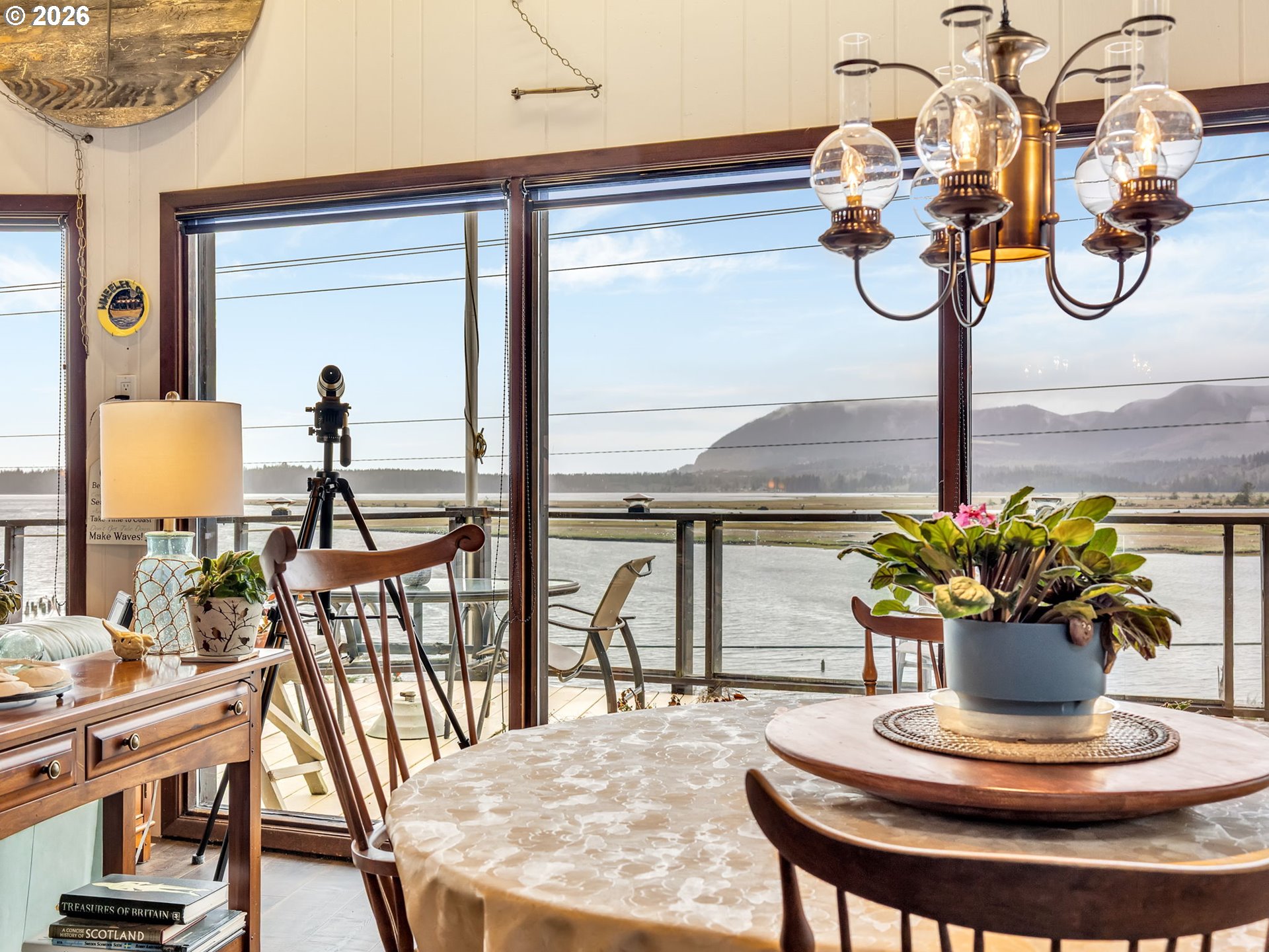 61 Gamble Street Wheeler, OR 97147 - Photo 19 of 45 a dining room with furniture a potted plant and a chandelier