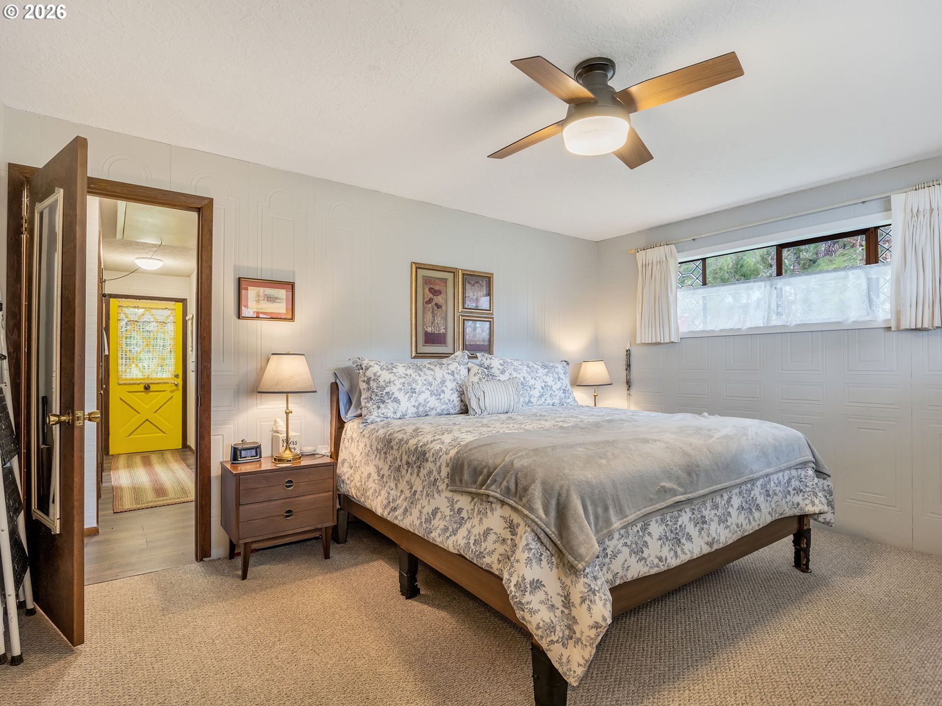 61 Gamble Street Wheeler, OR 97147 - Photo 23 of 45 a bedroom with a bed a window and a chandelier
