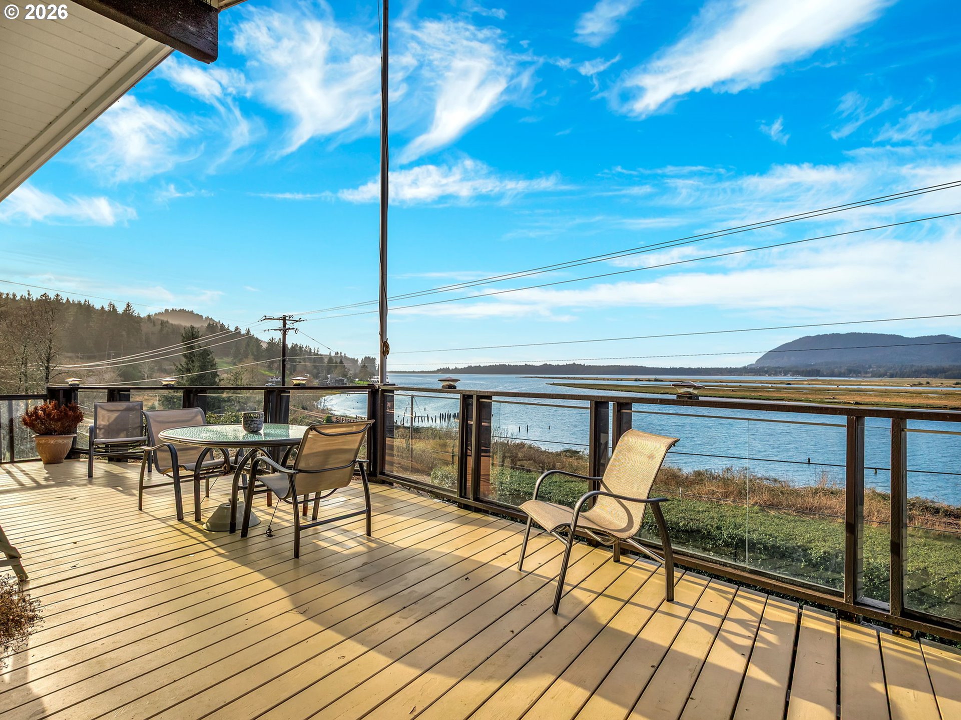 61 Gamble Street Wheeler, OR 97147 - Photo 36 of 45 a view of a balcony with chairs and wooden floor