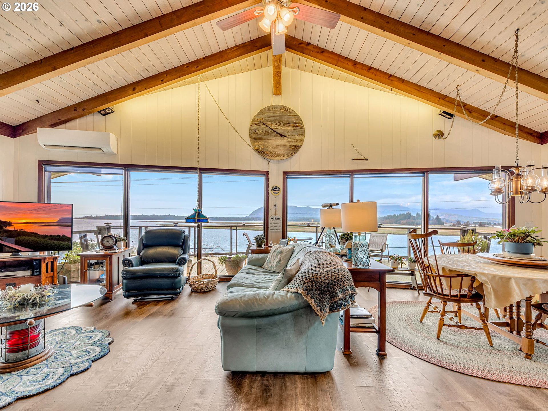 61 Gamble Street Wheeler, OR 97147 - Photo 5 of 45 a living room with furniture a chandelier and a large window