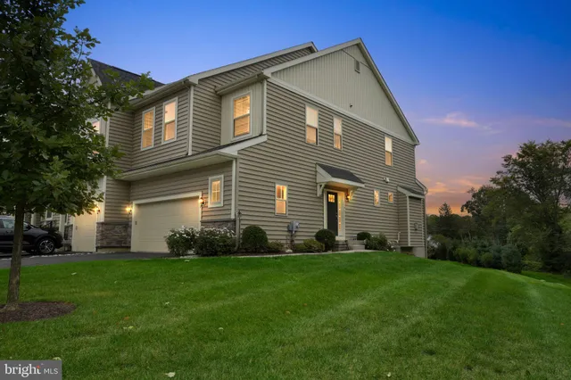 a front view of a house with a garden and yard