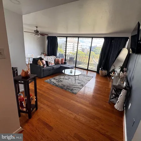 a living room with furniture and a floor to ceiling window