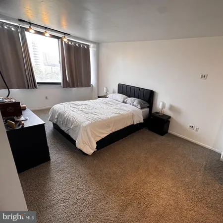 a bedroom with a bed and window