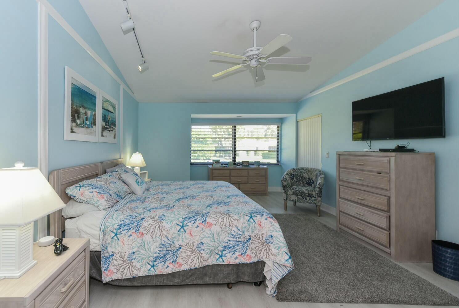 3736 Freshwater Drive Jupiter, FL 33477 - Photo 15 of 28 a bedroom with a bed and a flat screen tv
