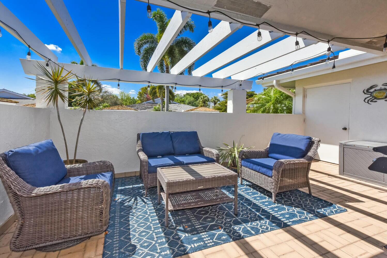 3736 Freshwater Drive Jupiter, FL 33477 - Photo 2 of 28 a outdoor living space with furniture and a potted plant