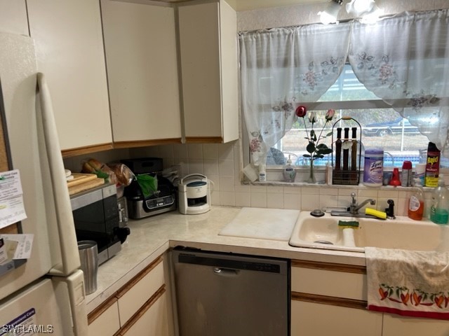 1691 North Hermitage Road Fort Myers, FL 33919 - Photo 8 of 15 a kitchen with stainless steel appliances a sink a stove and a refrigerator