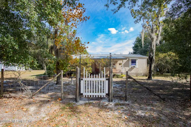 a view of a swimming pool with lawn chairs under an umbrella