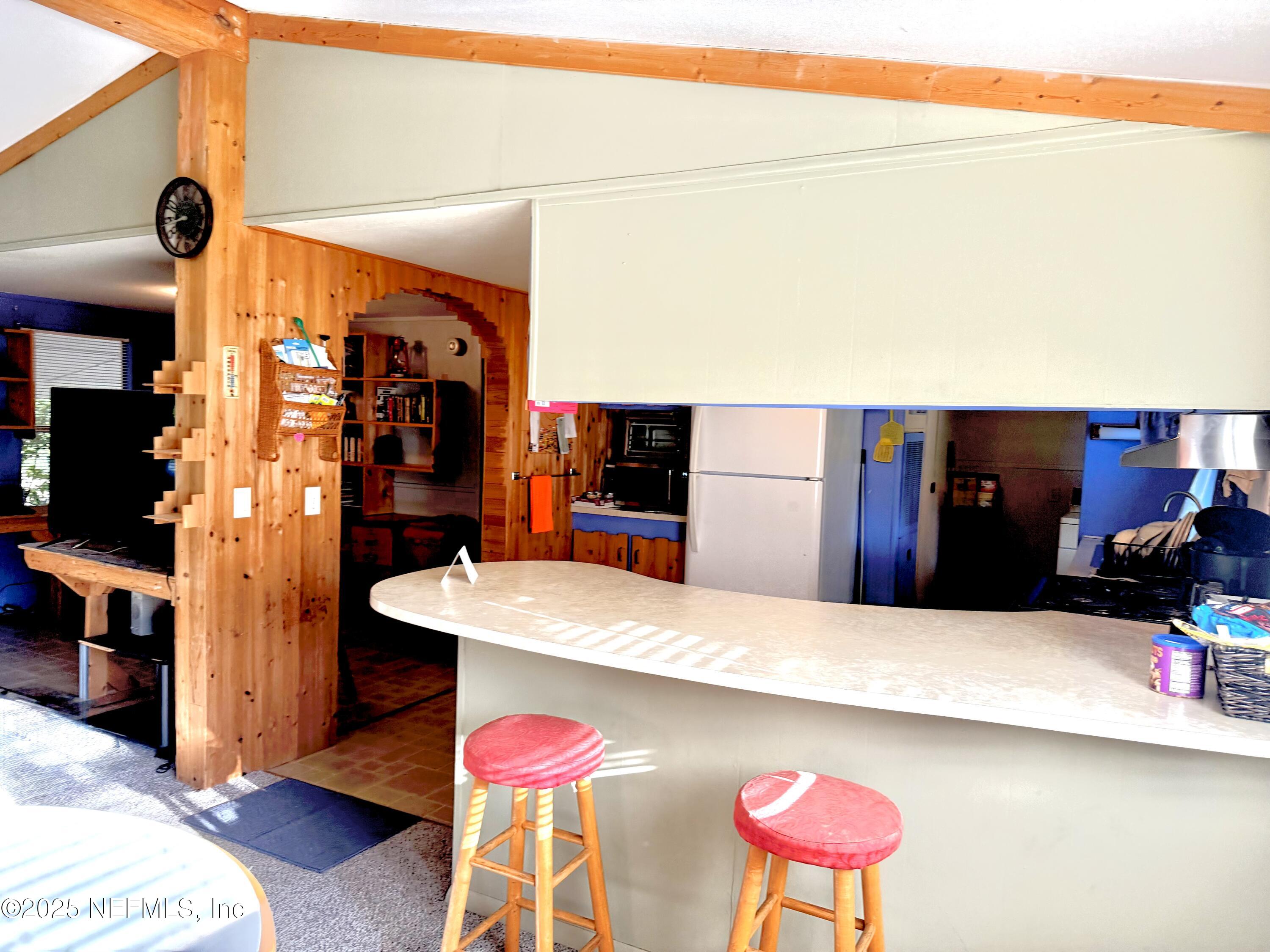 210 Lenore Avenue Interlachen, FL 32148 - Photo 23 of 43 a terrace of a building with table and chairs