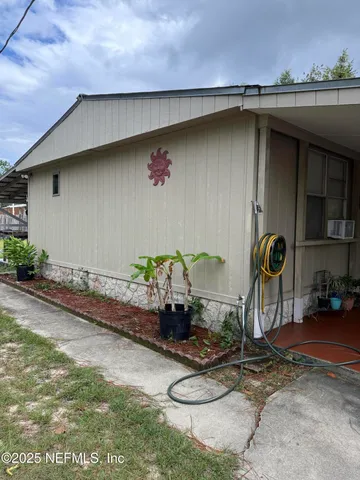 a view of a swimming pool with a bench and trees in the background