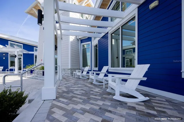 a view of a patio with table and chairs and potted plants