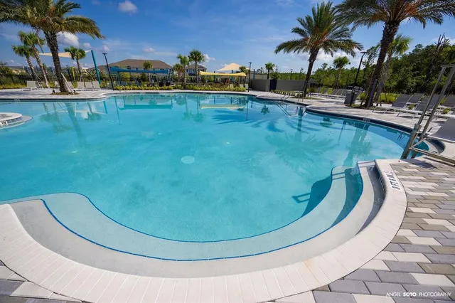 a view of a swimming pool with a table and chairs