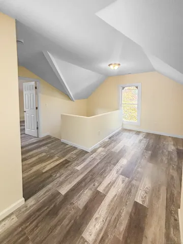 a view of a big room with wooden floor and a ceiling fan