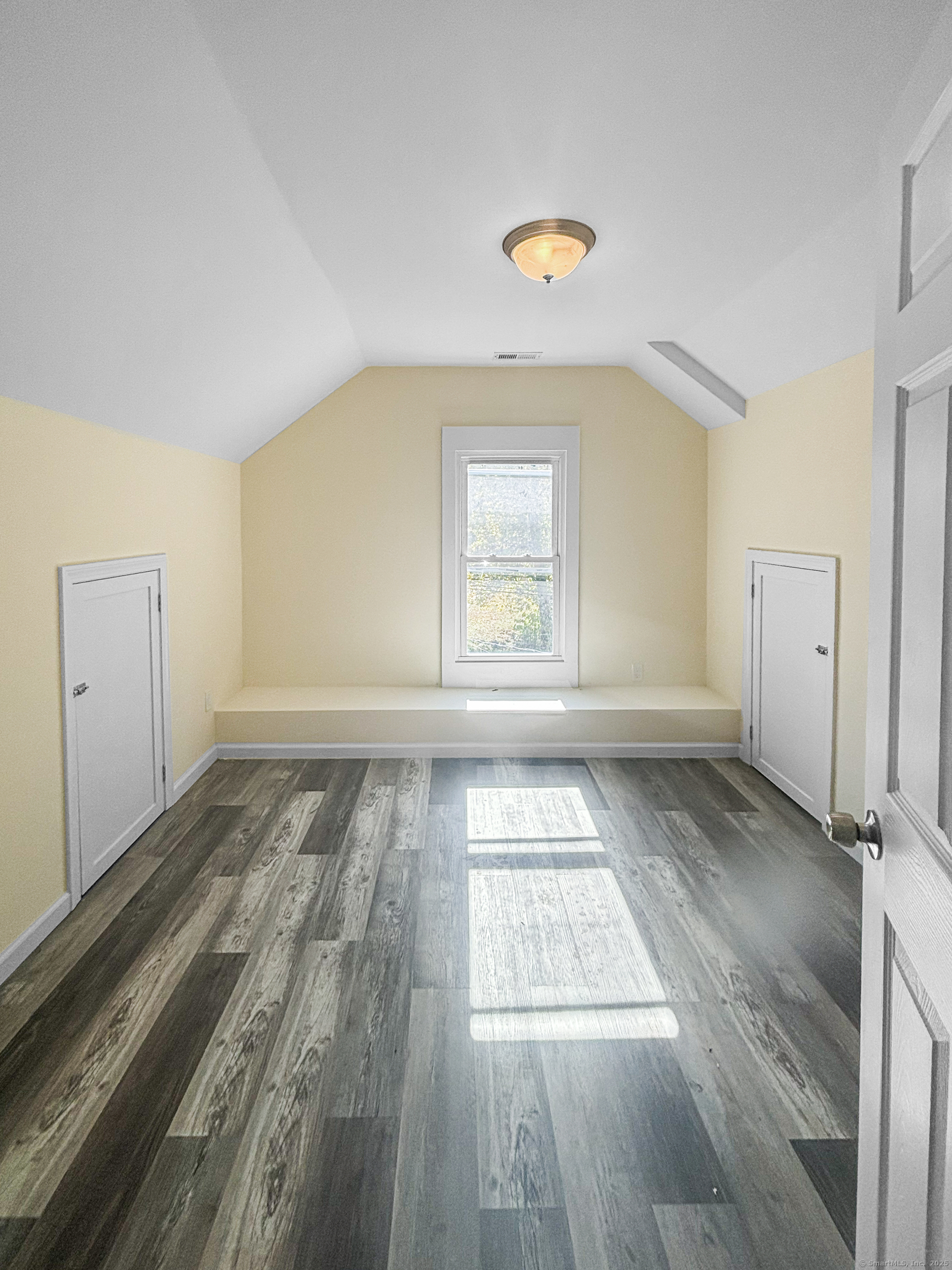 358 Pomeroy Avenue Meriden, CT 06450 - Photo 17 of 36 an empty room with wooden floor and windows