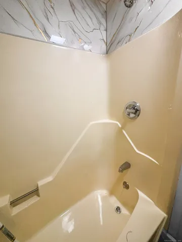 a bathroom with a white bath tub