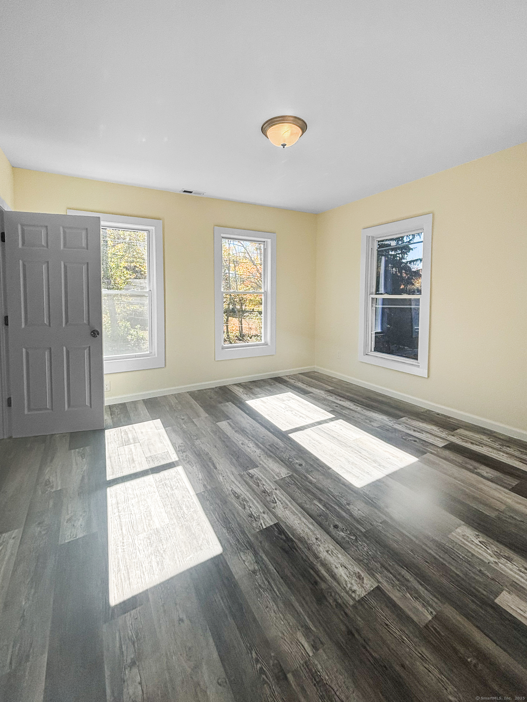 358 Pomeroy Avenue Meriden, CT 06450 - Photo 30 of 36 an empty room with wooden floor and windows