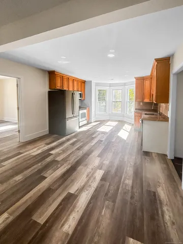 a view of livingroom with kitchen and wooden floor