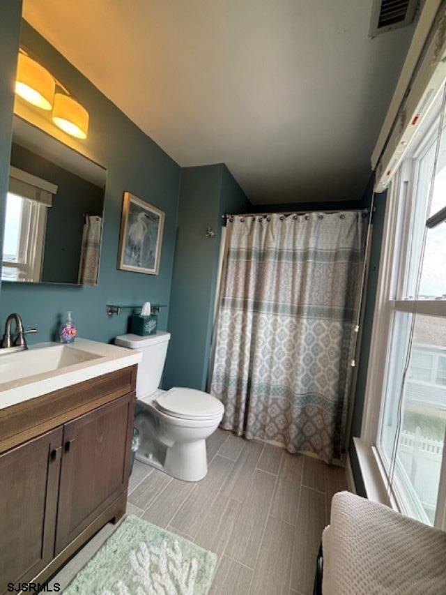 1328 Ouimet Road Brigantine, NJ 08203 - Photo 16 of 33 a bathroom with a sink toilet and window
