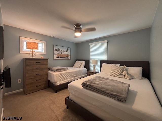 1328 Ouimet Road Brigantine, NJ 08203 - Photo 22 of 33 a bed room with two bed and a ceiling fan