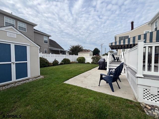 1328 Ouimet Road Brigantine, NJ 08203 - Photo 23 of 33 a backyard of a house with table and chairs