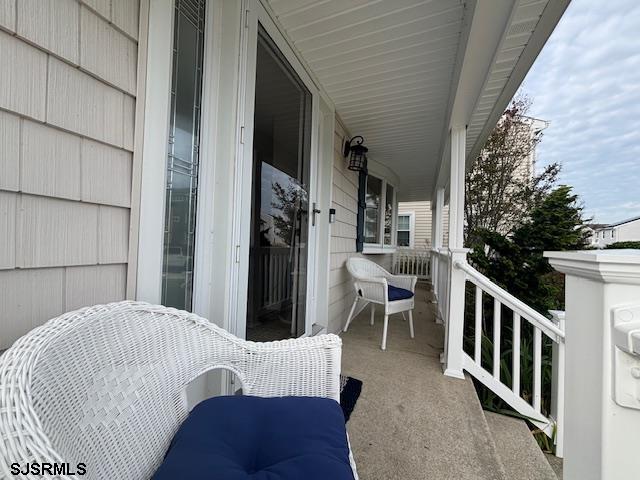 1328 Ouimet Road Brigantine, NJ 08203 - Photo 24 of 33 a balcony view with two couches and a fireplace