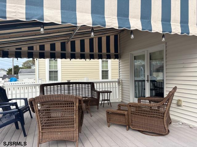 1328 Ouimet Road Brigantine, NJ 08203 - Photo 25 of 33 a view of a patio with couches chairs and wooden floor