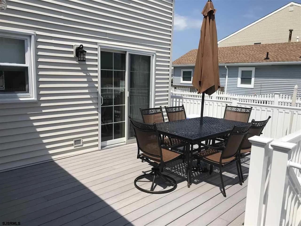 1328 Ouimet Road Brigantine, NJ 08203 - Photo 27 of 33 a view of a dinning table and chairs in the patio