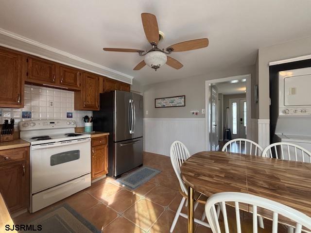 1328 Ouimet Road Brigantine, NJ 08203 - Photo 7 of 33 a kitchen with stainless steel appliances granite countertop a stove a sink dishwasher a refrigerator with white cabinets and wooden floor