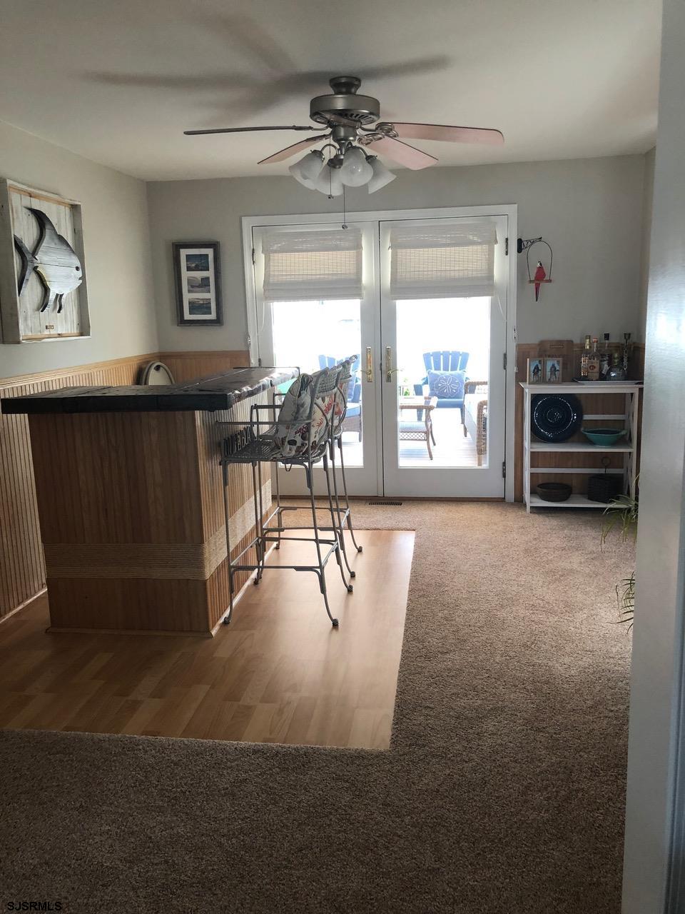 1328 Ouimet Road Brigantine, NJ 08203 - Photo 8 of 33 a living room with furniture a flat screen tv and a large window