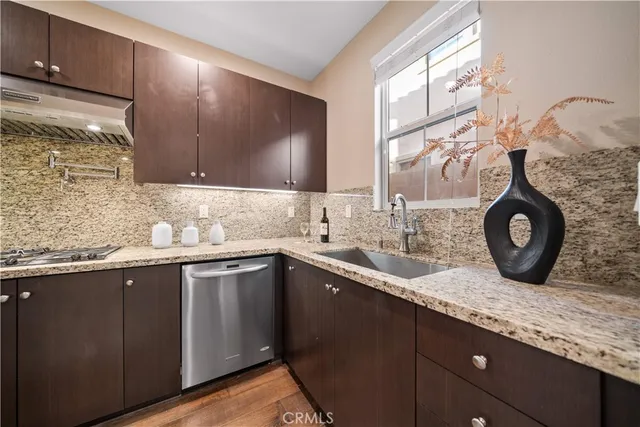 a living room with furniture large window and wooden floor