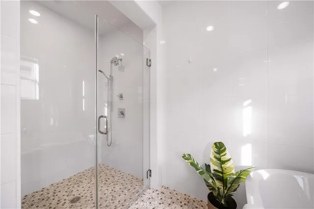 a white toilet sitting next to a bath tub